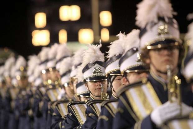 Nighttime trumpet section members locked in with focused game faces